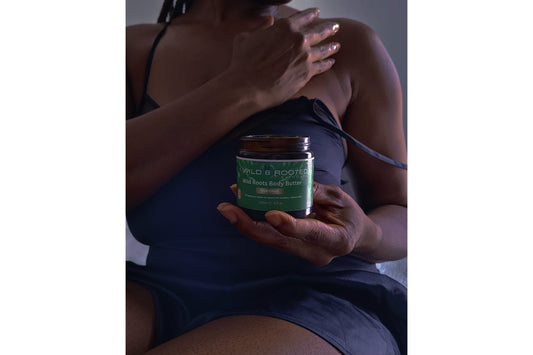 Woman applying body butter to her shoulders